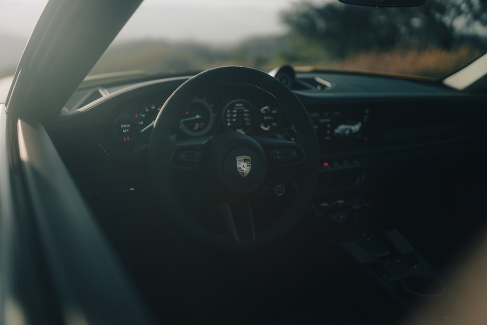 the interior of a car with a steering wheel and dashboard