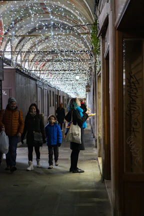 A group of excited travelers dressed in themed gear exploring a dimly lit Seoul alley.