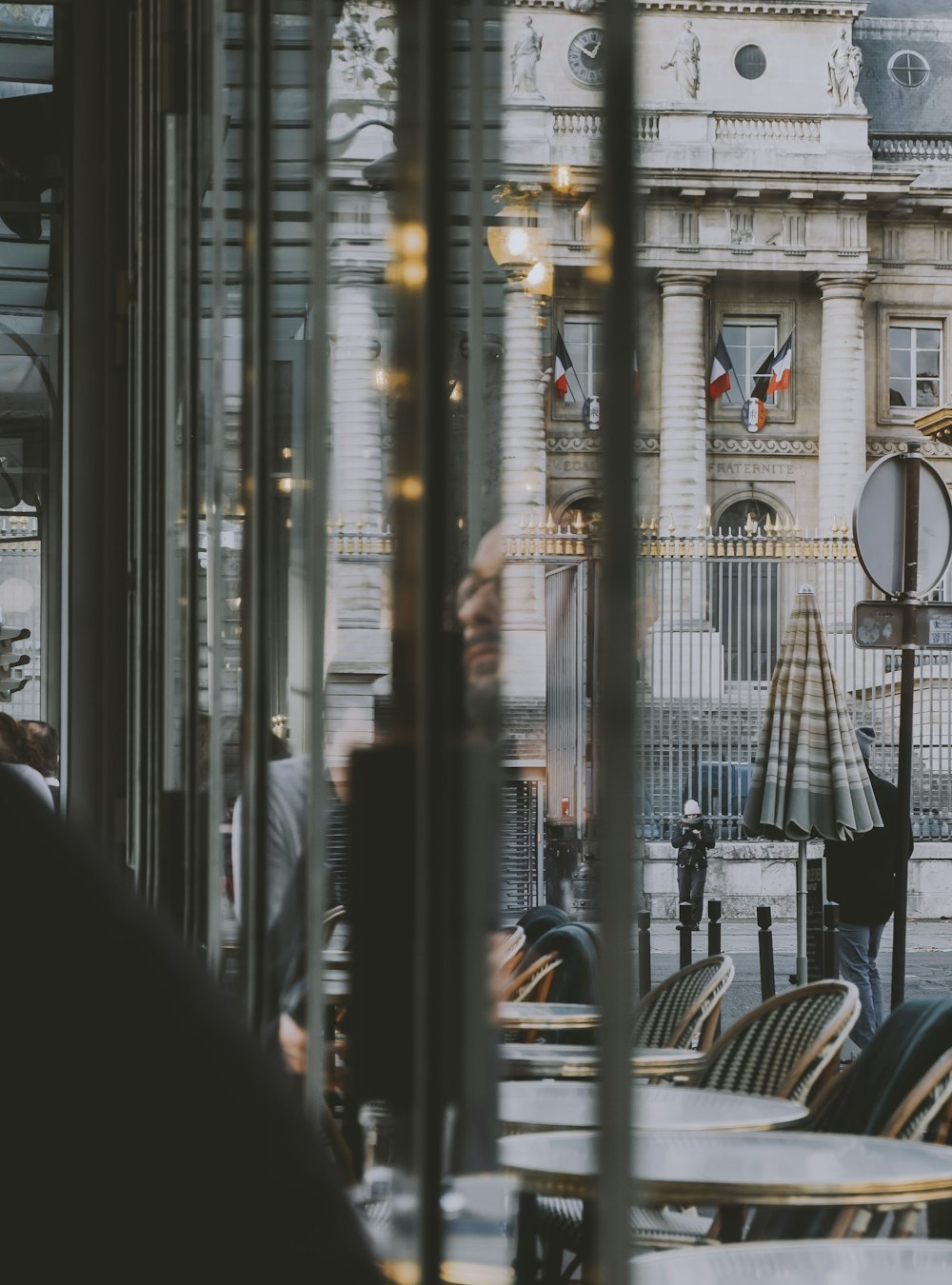 a group of people sitting at a table in front of a building