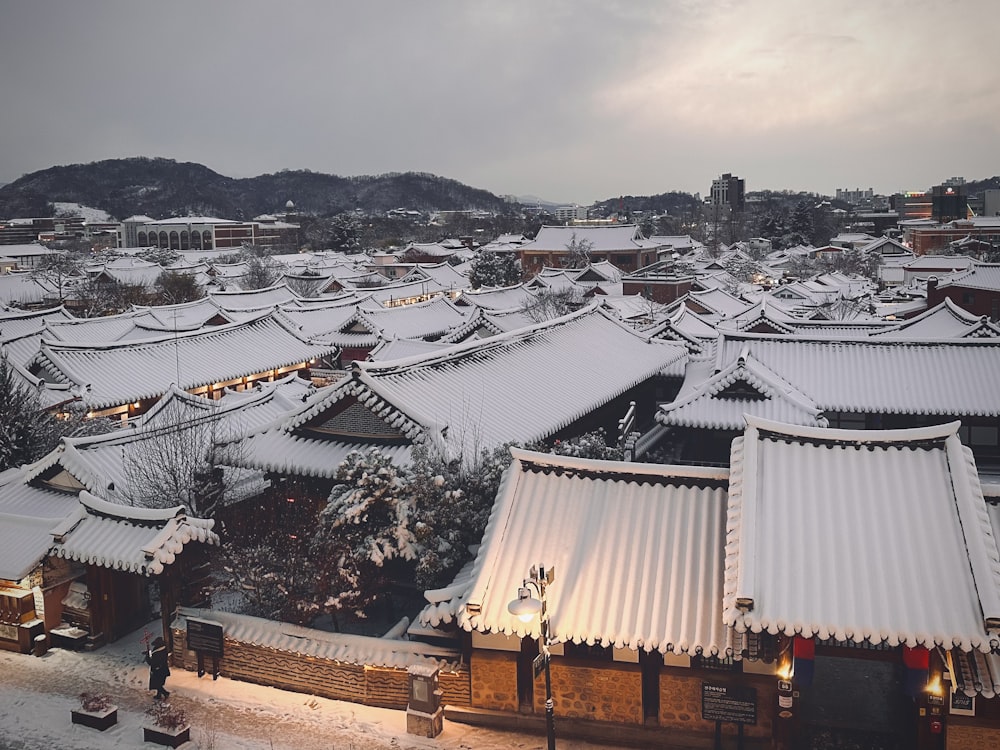 a snow covered city with a lot of buildings