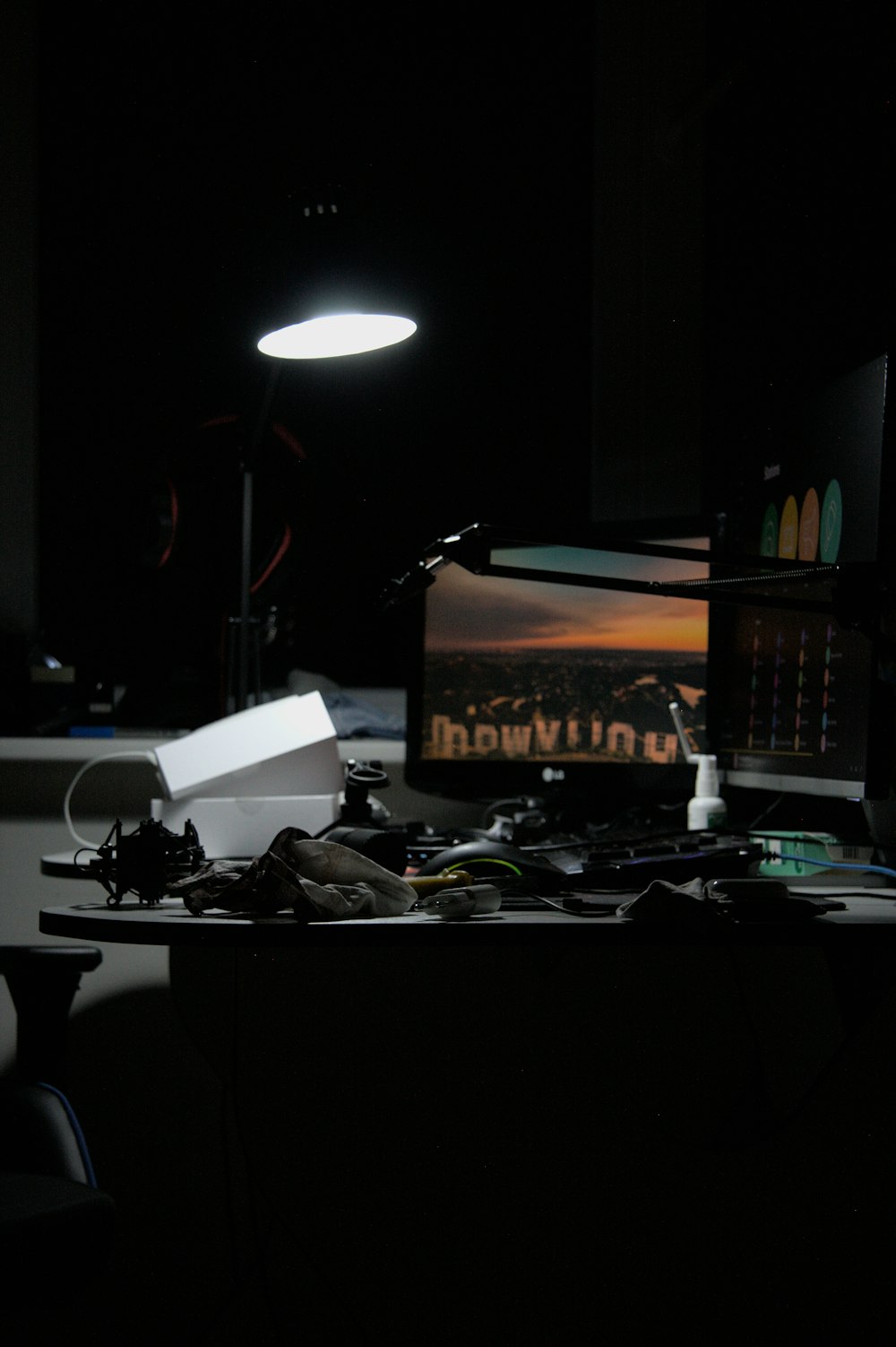 a desk with a computer and a lamp on it