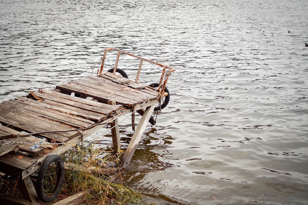 an old wooden boat sitting on top of a body of water