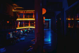 A softly lit street in Jiufen at dusk, glowing with warm lantern light and gentle shadows.