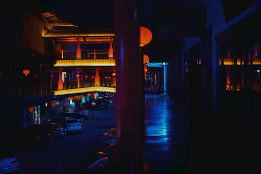 A softly lit street in Jiufen at dusk, glowing with warm lantern light and gentle shadows.