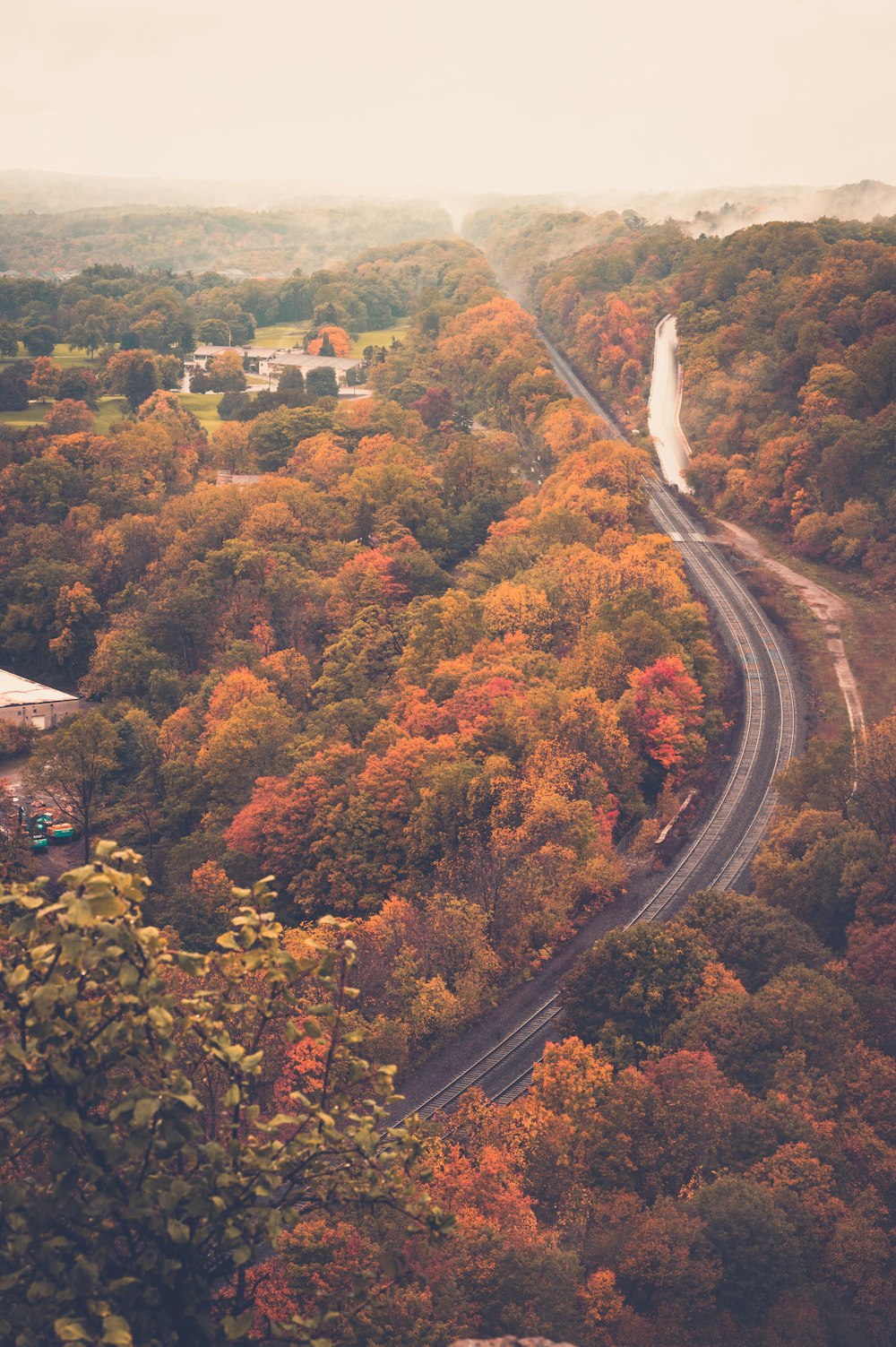 an aerial view of a winding road surrounded by trees