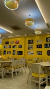 a restaurant with yellow walls and yellow chairs