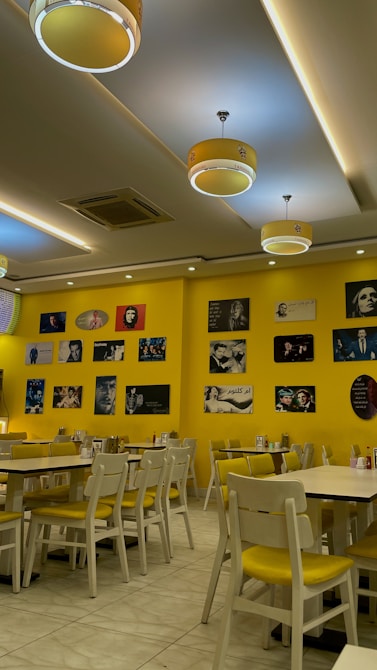 a restaurant with yellow walls and yellow chairs