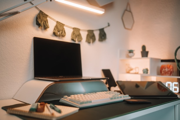 A neatly organized workspace with modern tools and minimalist décor elements on a wooden desk.