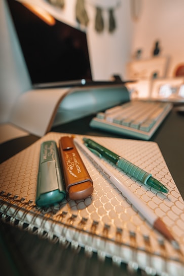Close-up of smooth writing instruments and durable binding tools designed for everyday office use.