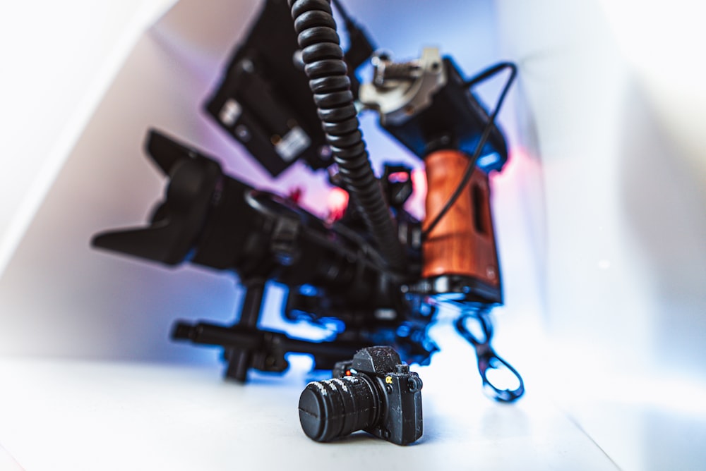 a couple of cameras sitting on top of a white table