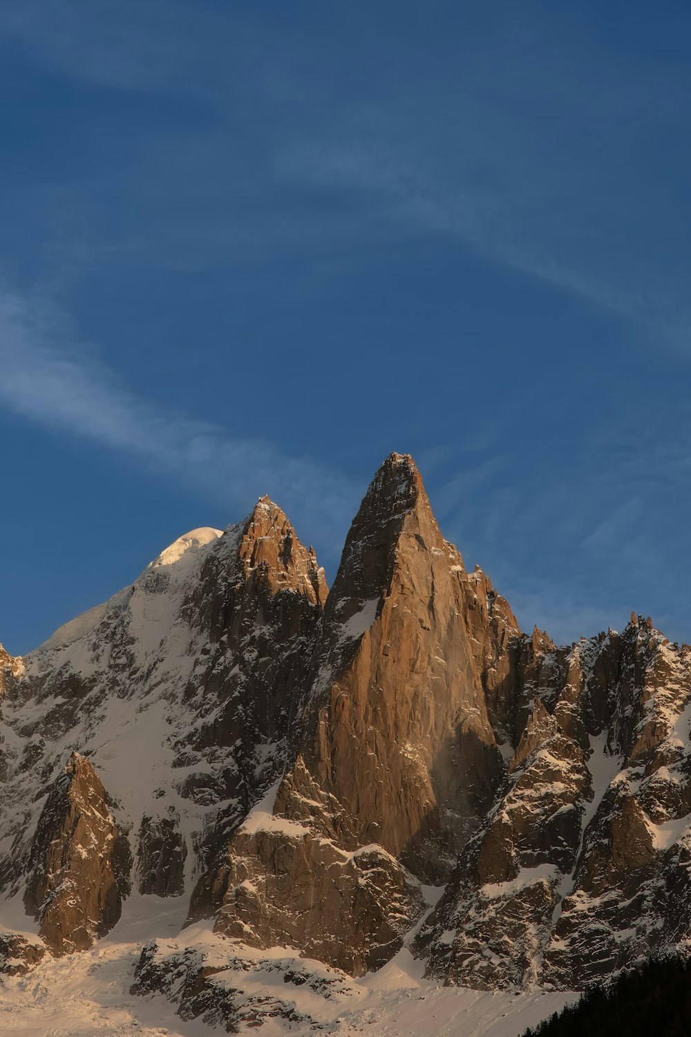 a snow covered mountain under a blue sky