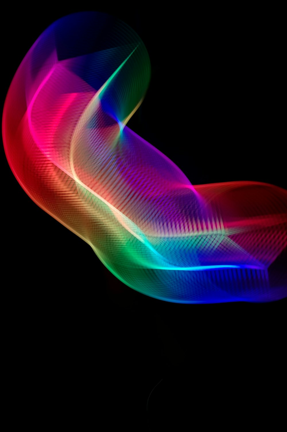 a blurry photo of a colorful object on a black background