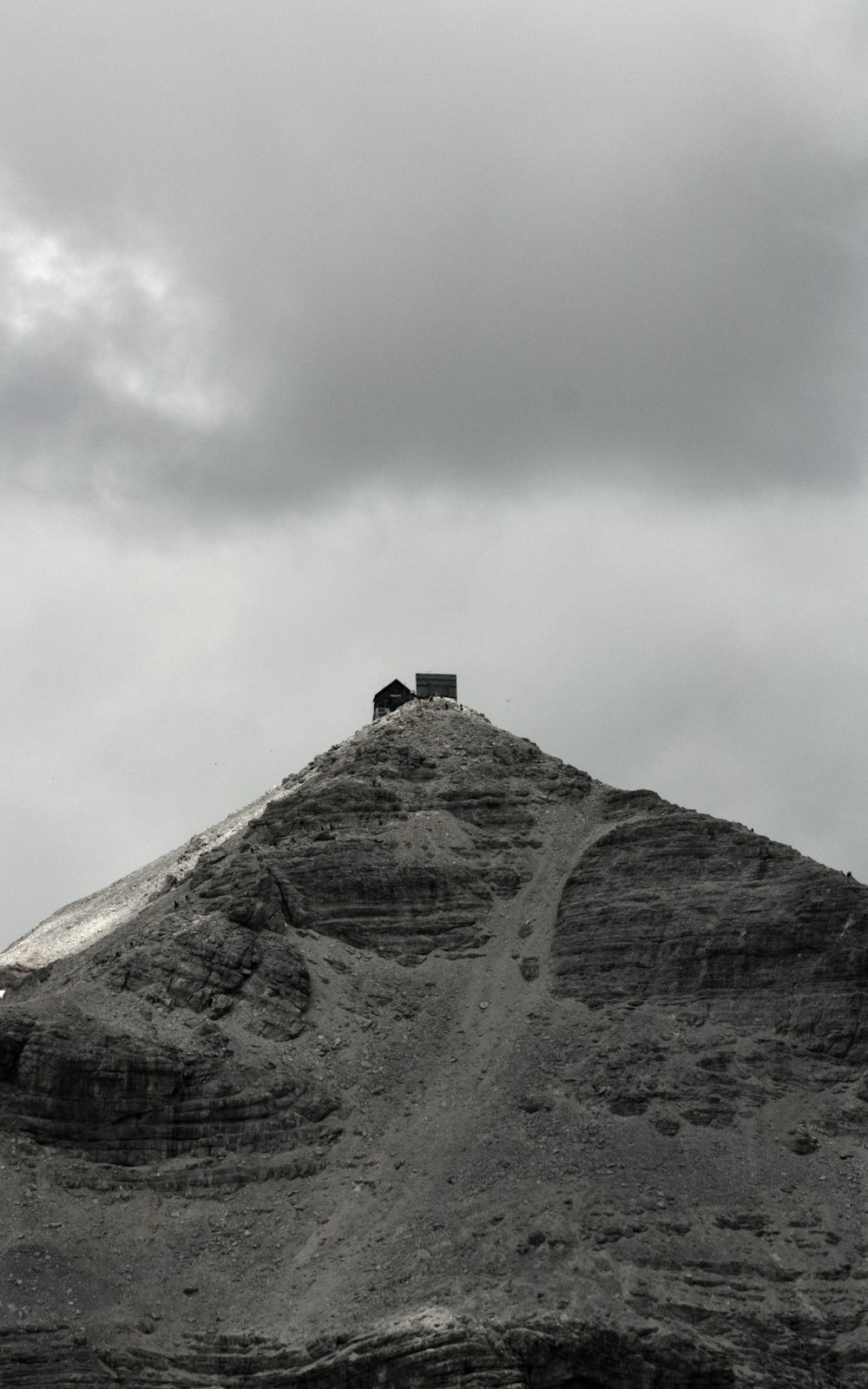 a couple of sheep standing on top of a mountain