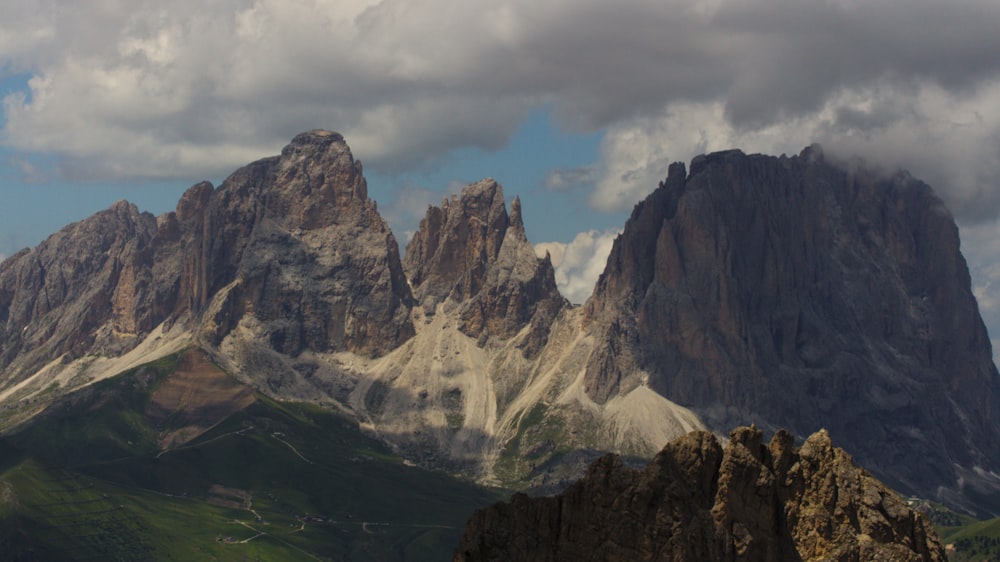 a mountain range with a few clouds in the sky