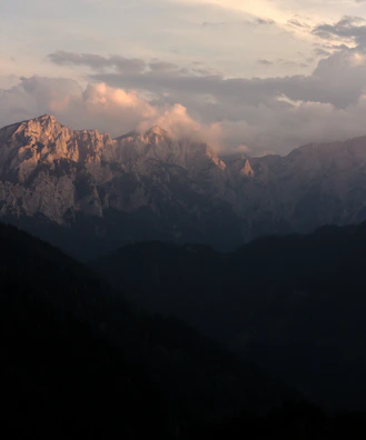 A vibrant mountain scene capturing the play of light and shadow in acrylic.