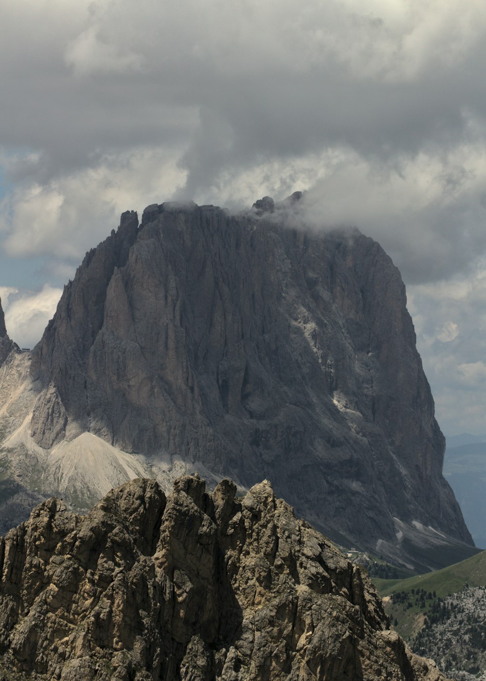 a large mountain with a very tall mountain in the background