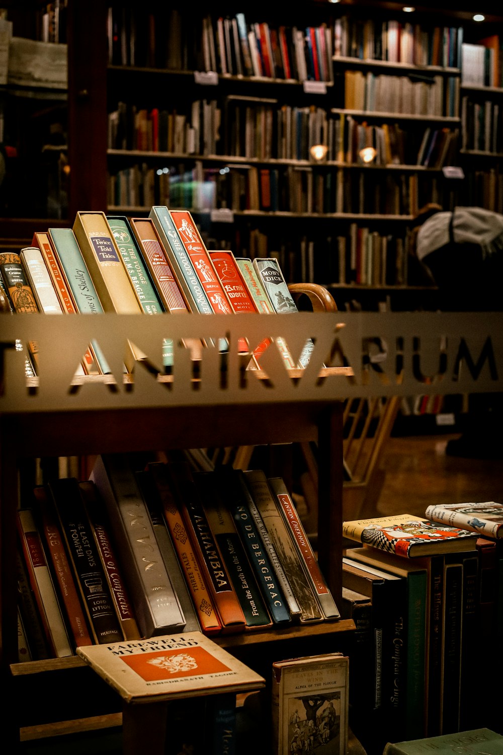 a bookshelf filled with lots of books in a library