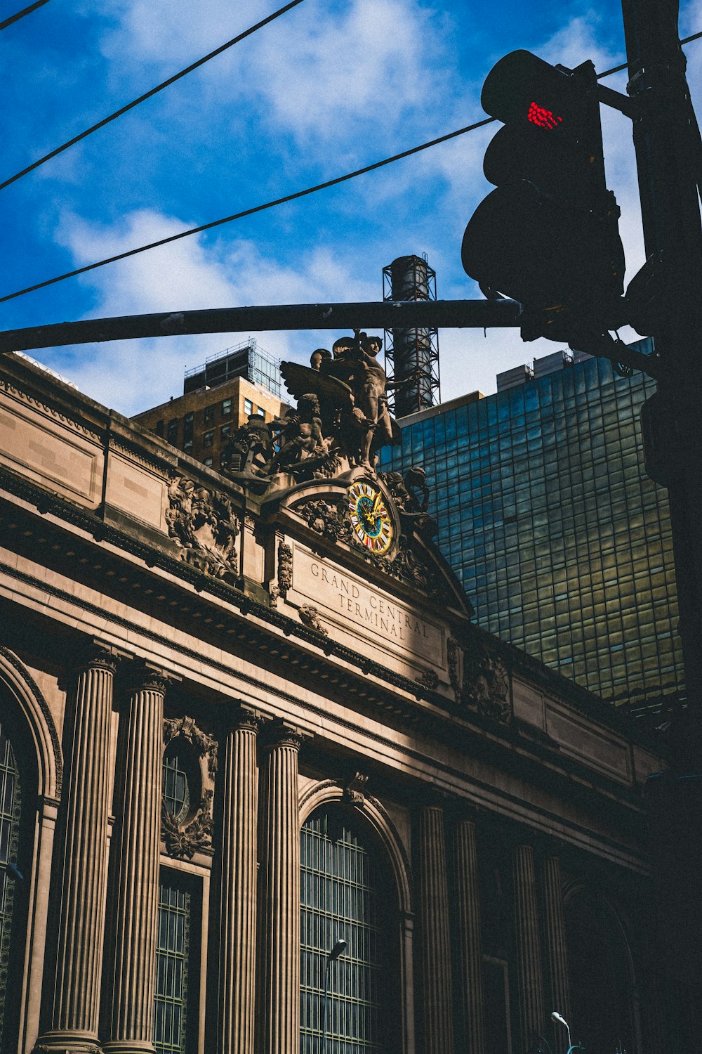 a traffic light hanging over a street next to a tall building