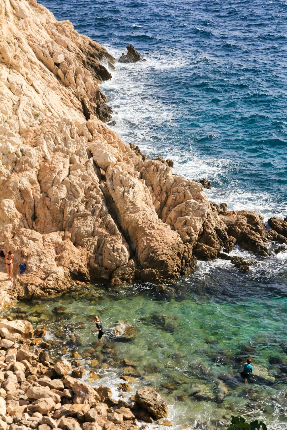 a couple of people swimming in a body of water