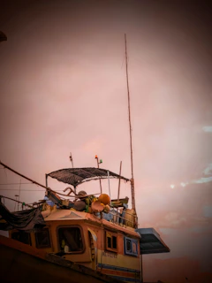 A cozy fishing boat at dawn with green and black fishing gear neatly arranged.