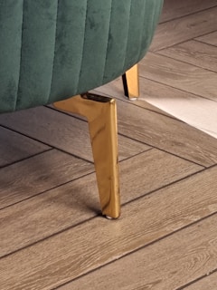 a close up of a chair on a wooden floor