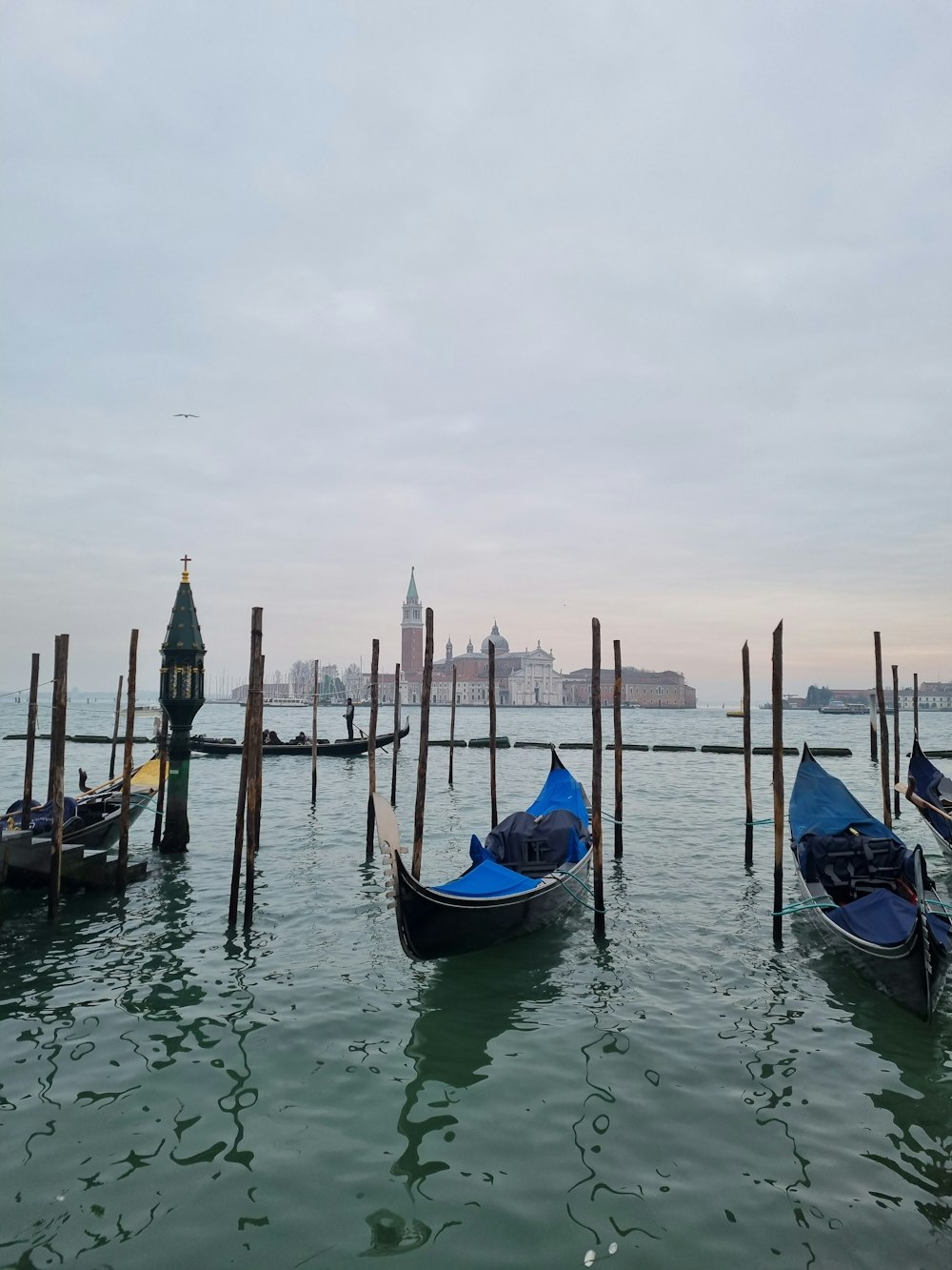 a couple of gondolas that are sitting in the water