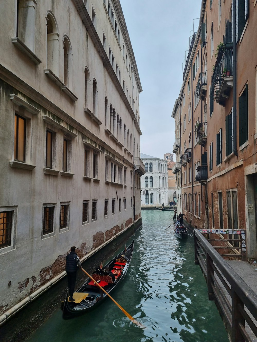 a gondola in a canal between two buildings