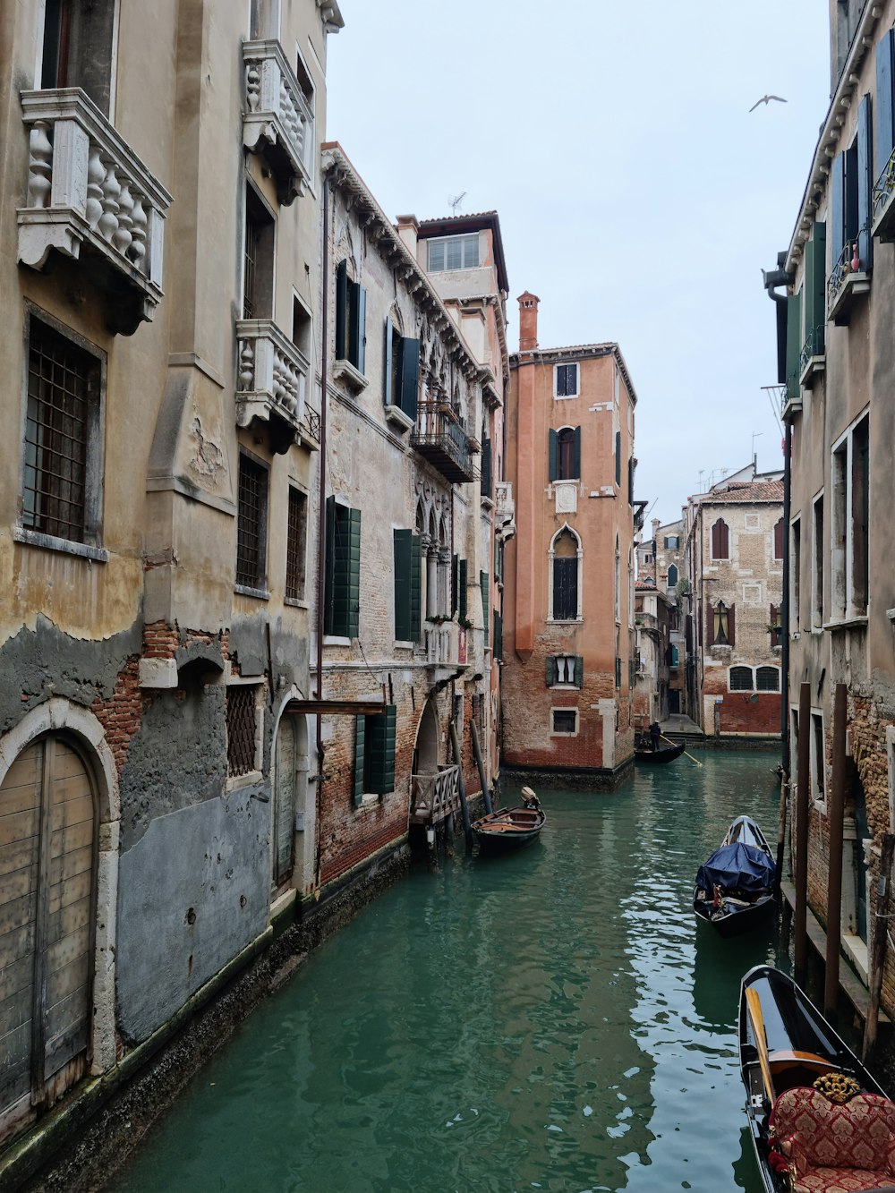 a narrow canal in a city filled with buildings