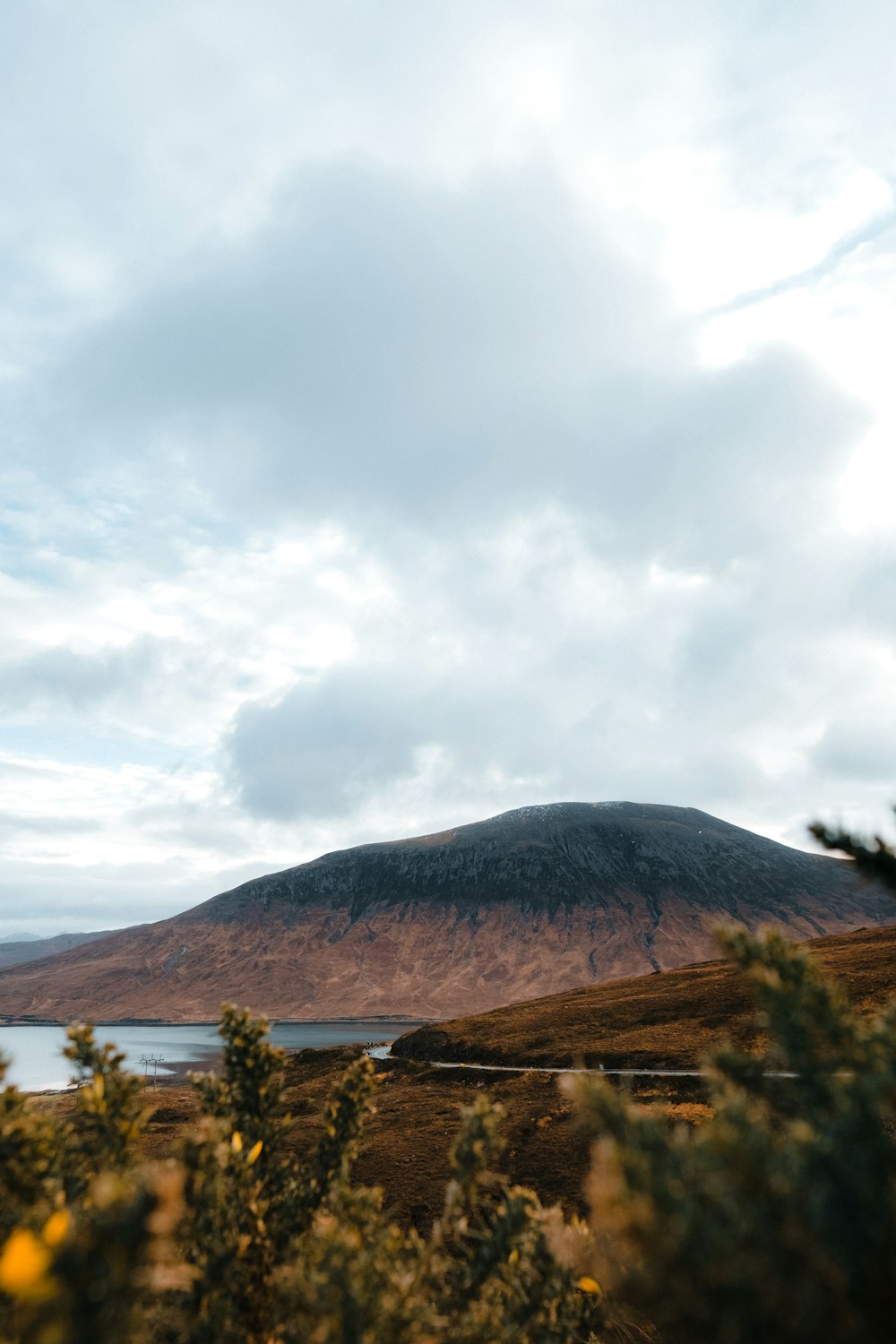 a view of a mountain with a lake in the foreground