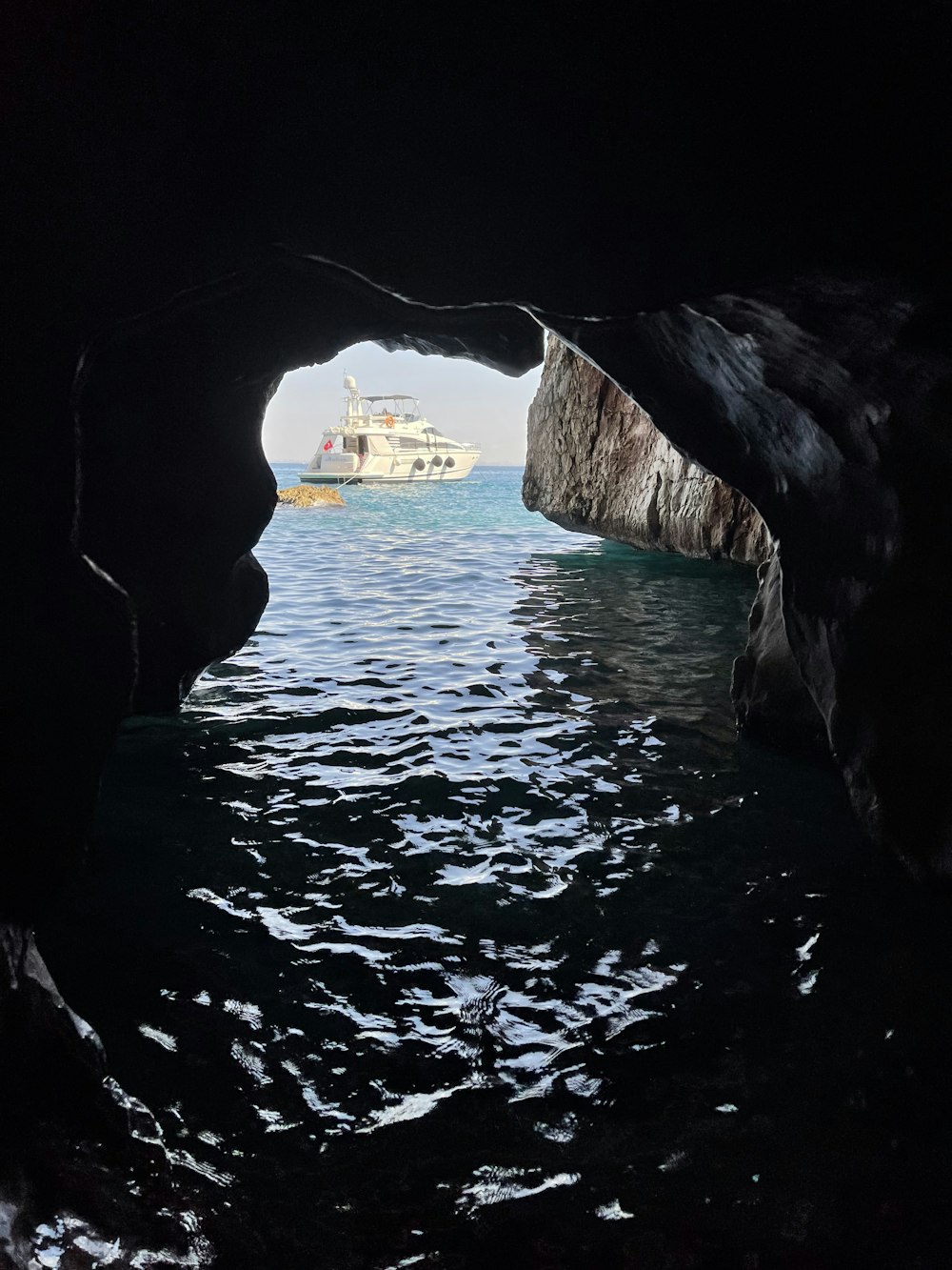 a boat is coming out of a cave