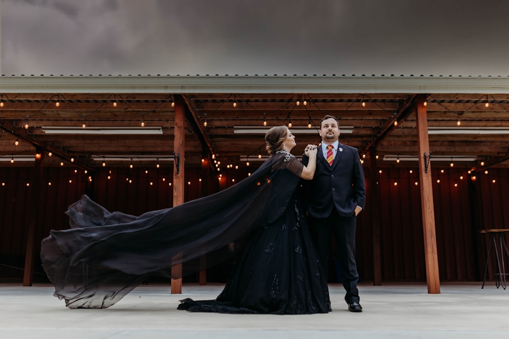 a man and a woman standing in front of a building