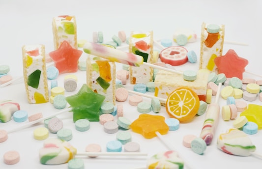 a pile of colorful candies on a white surface