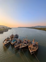 A peaceful river scene near Gauragarh with fishermen preparing their boats at dawn.