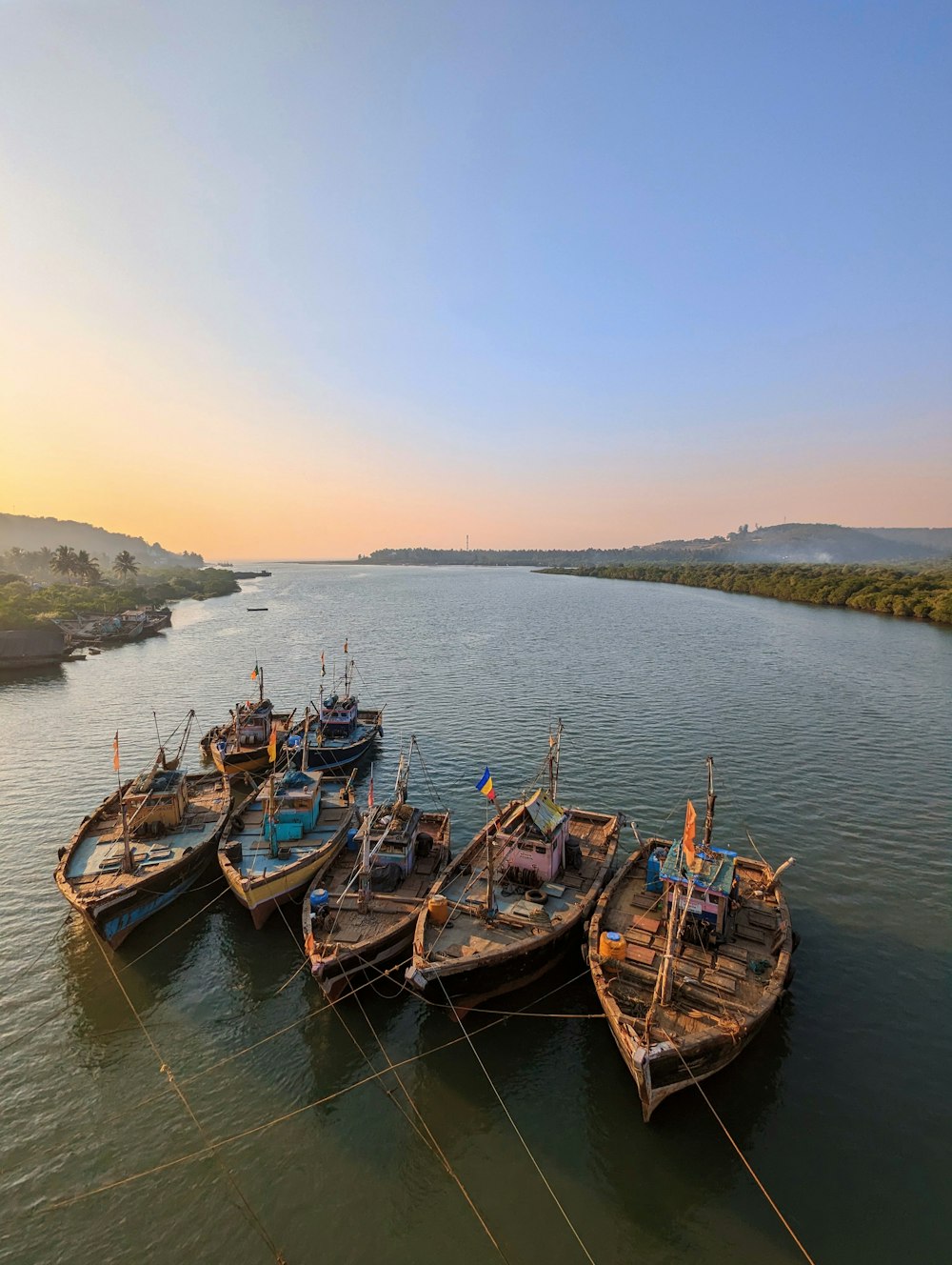 a group of boats sitting on top of a river