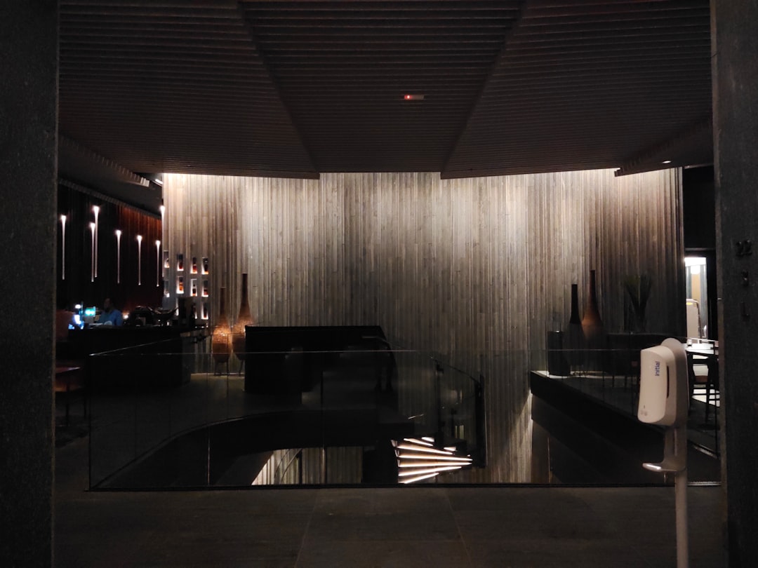 a room with a large mirror and a black table,