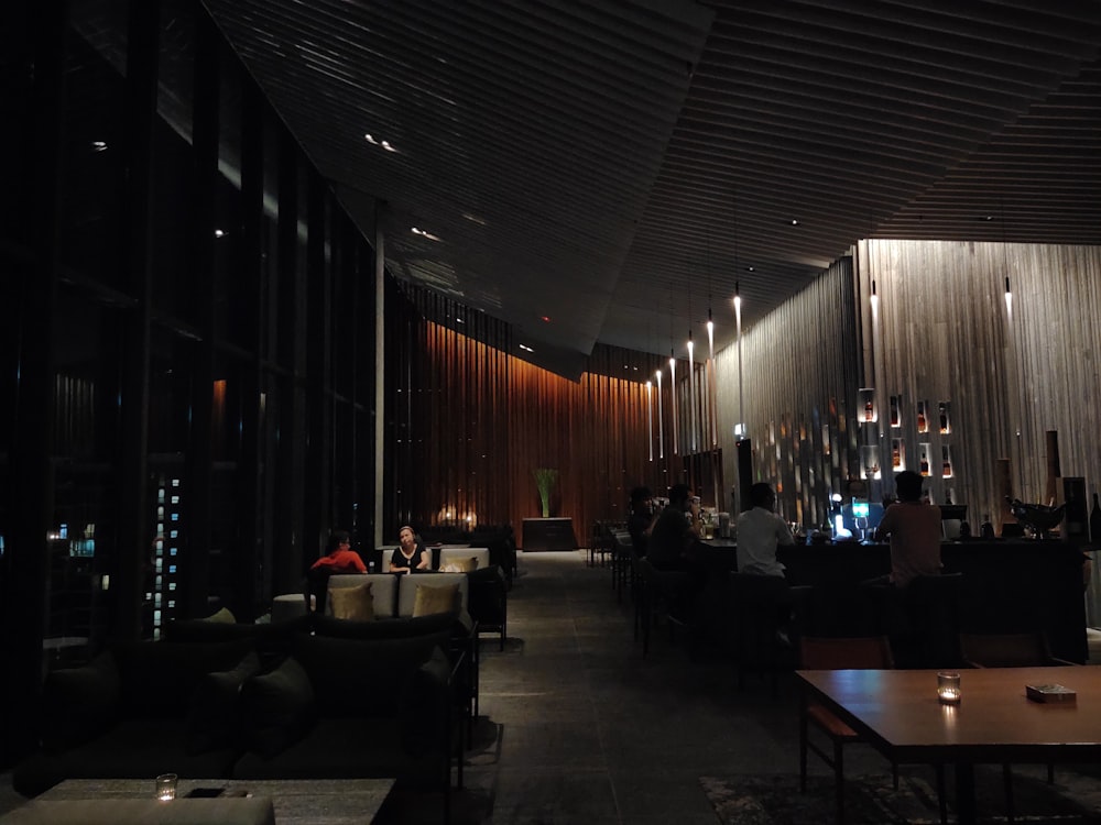 a dimly lit restaurant with people sitting at tables