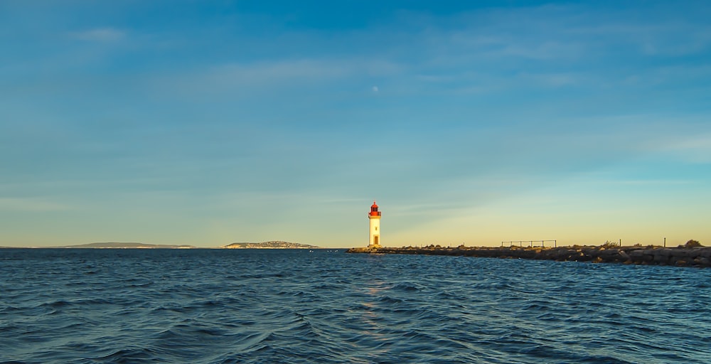 a light house in the middle of a body of water