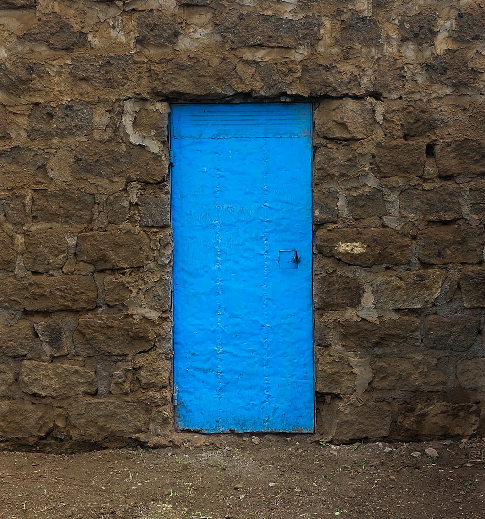 a blue door on a stone building