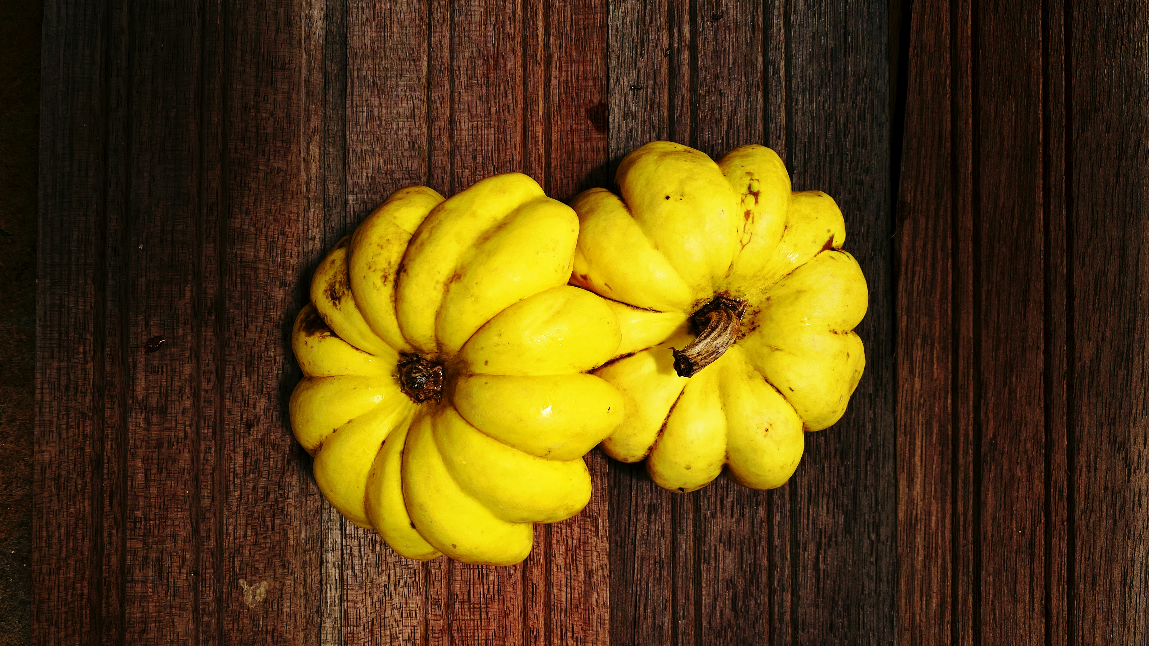 a bunch of bananas sitting on top of a wooden table