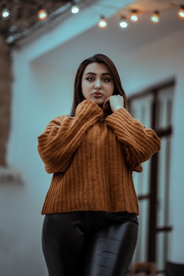 A model wearing a long-sleeve top in a cozy outdoor setting.