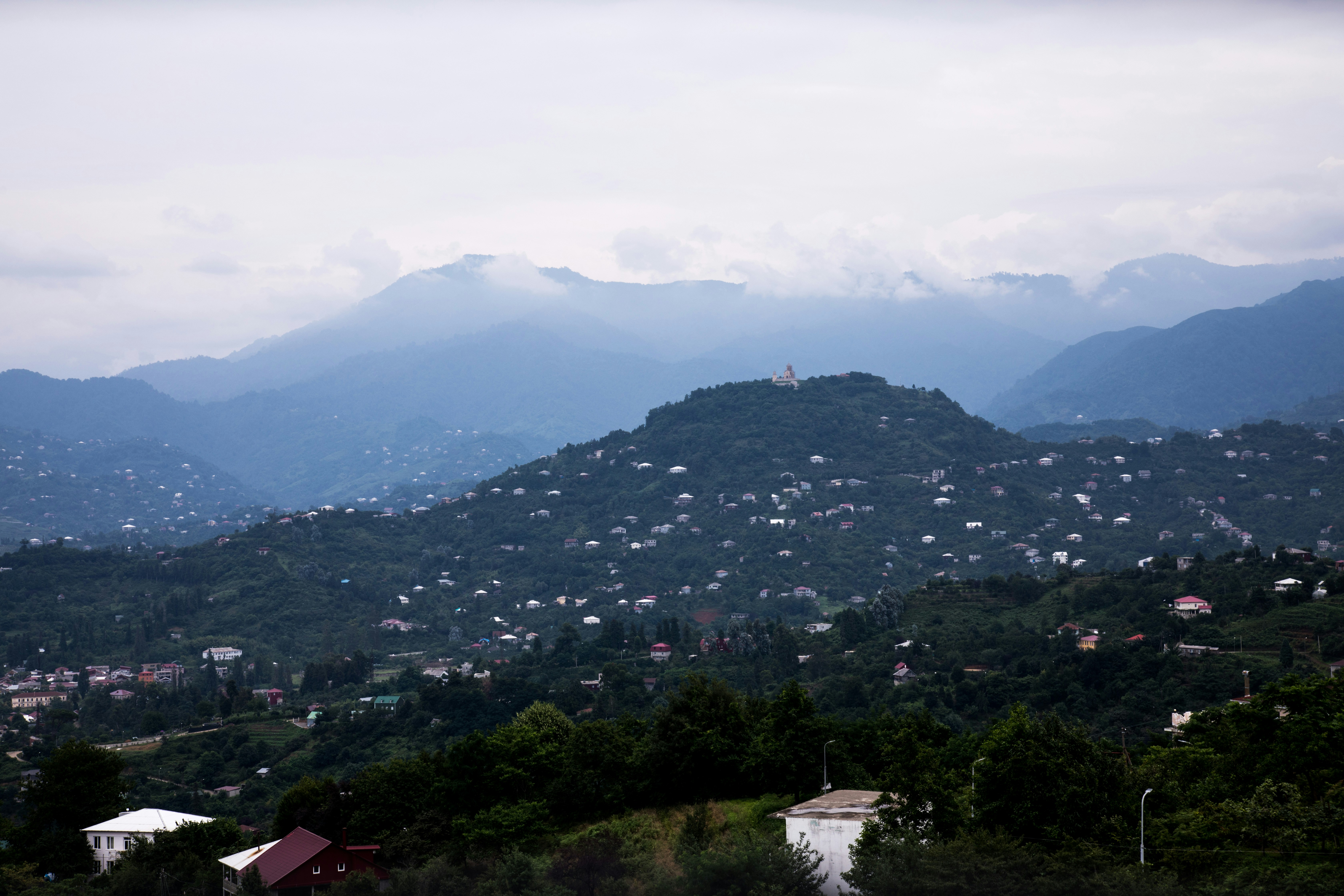 a view of a mountain range with houses on it