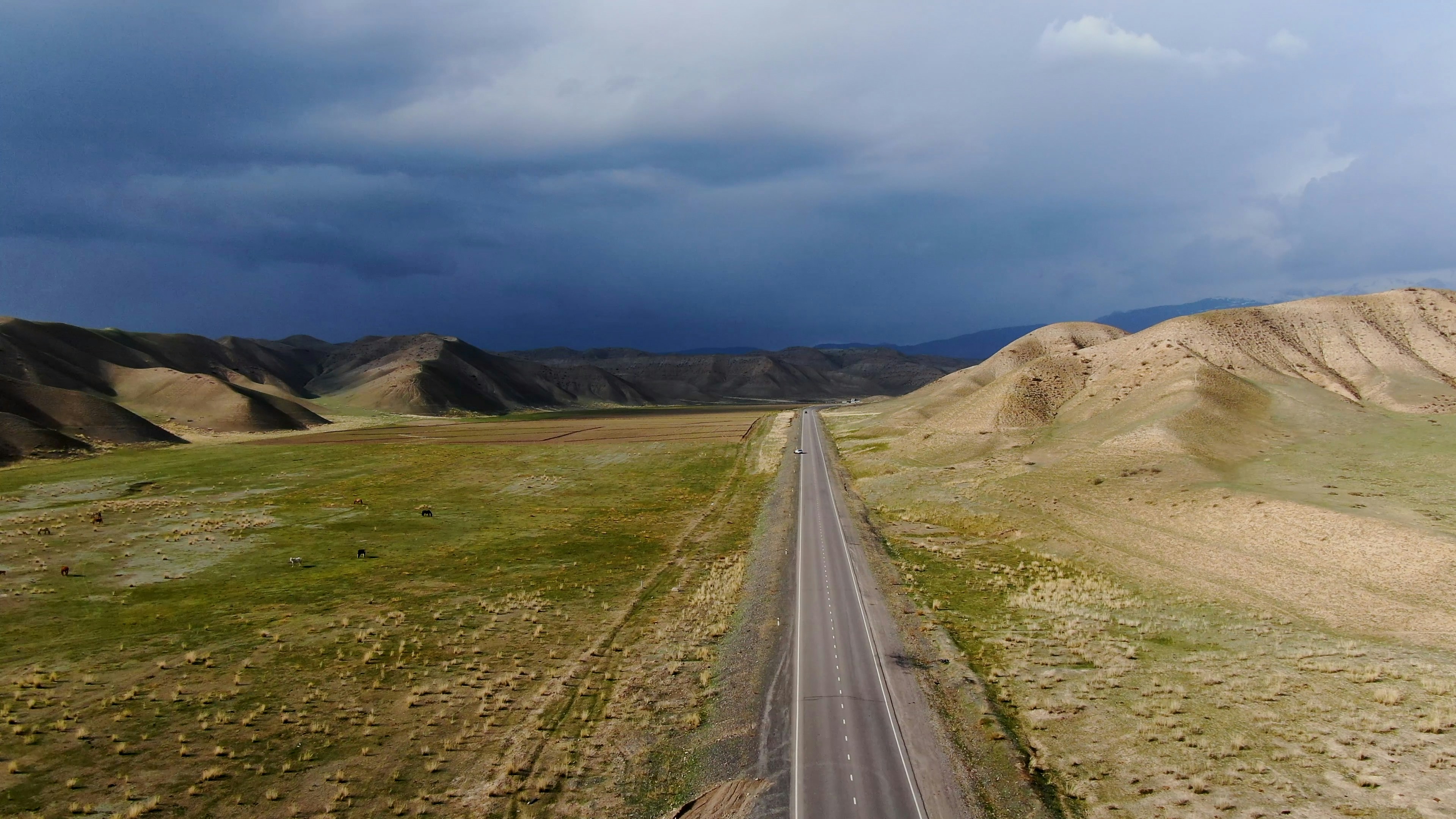 an aerial view of a road in the desert