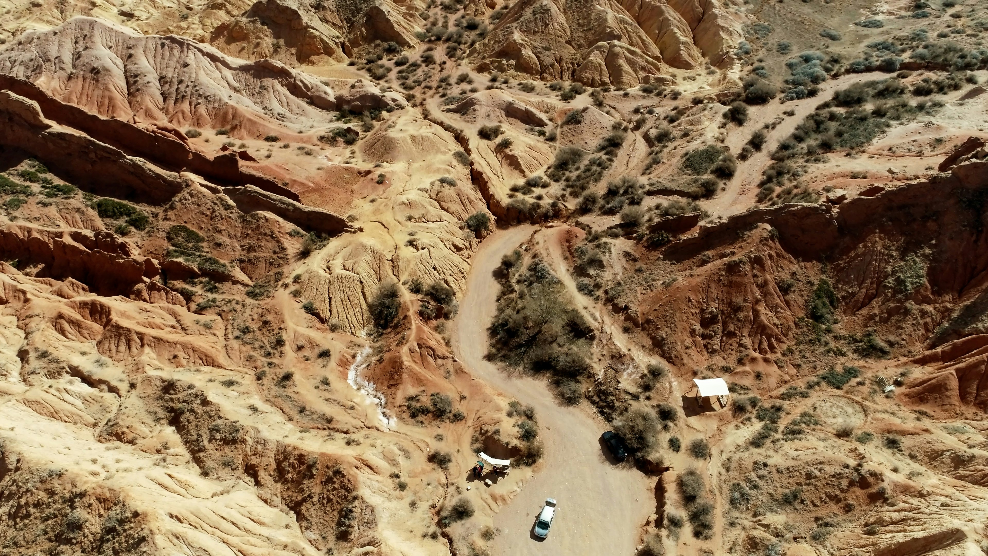 an aerial view of a road in the mountains