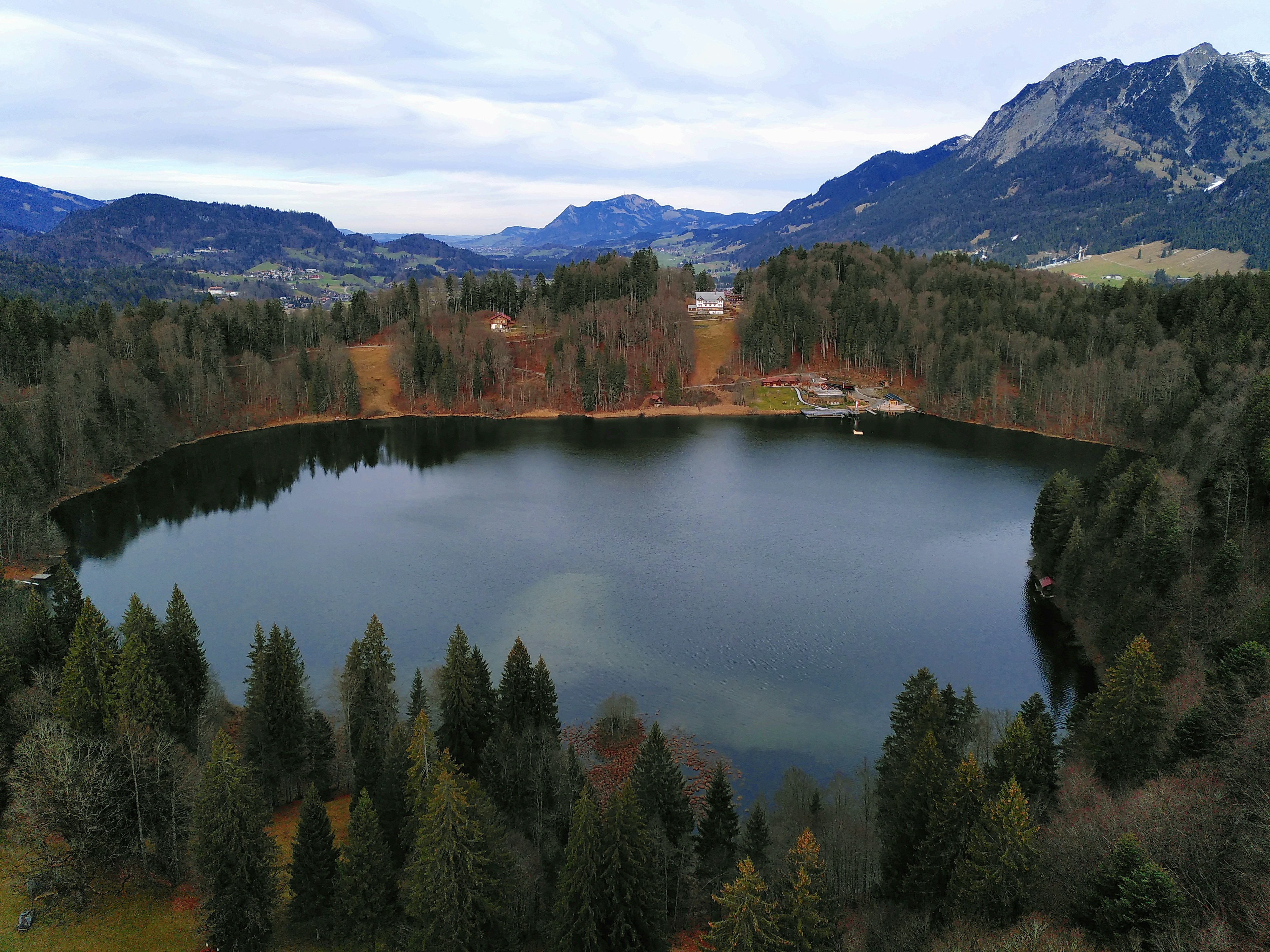 an aerial view of a lake surrounded by mountains