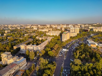 An aerial view of Riyadh city streets bustling with activity under a clear blue sky.