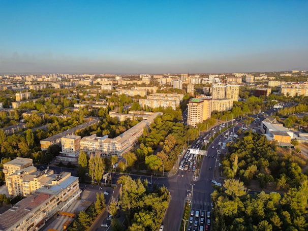 An aerial view of Riyadh city streets bustling with activity under a clear blue sky.