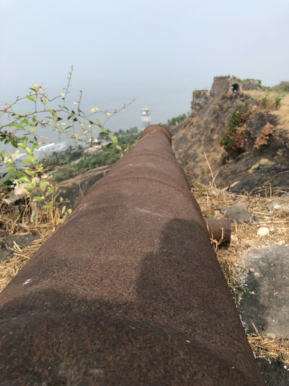 a very long pipe sitting on the side of a hill