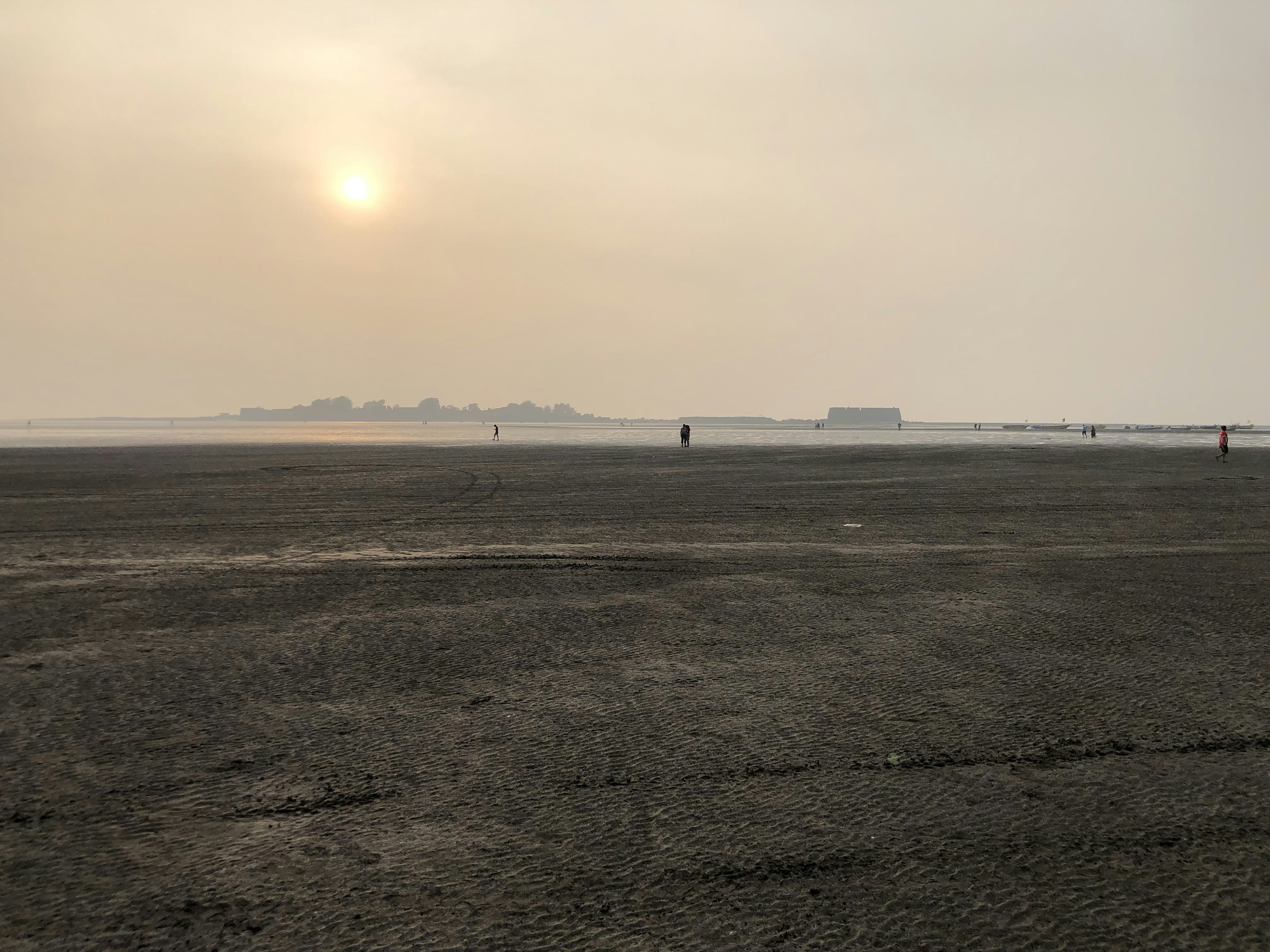 a person flying a kite on a sandy beach