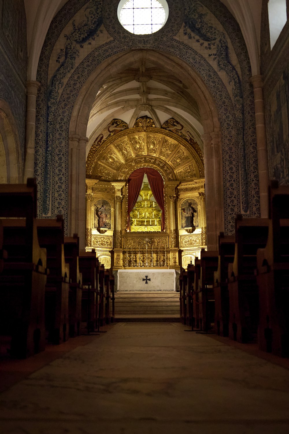 the interior of a church with pews and a gold alter
