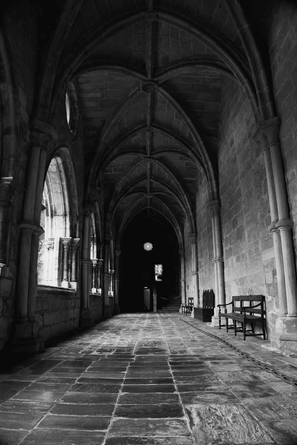 a black and white photo of a long hallway